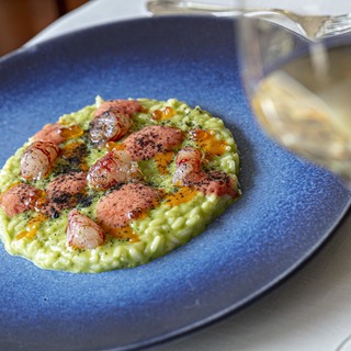 Risotto mantecato al pesto con gambero di santa margherita ligure  bisque  uova di salmone  polvere al nero di seppia e pomodoro del piennolo %c2%a9 emanuele rossi